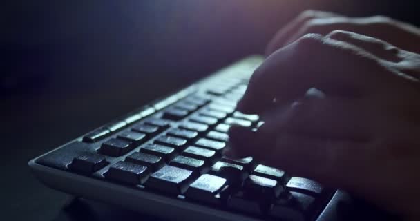 Typing on keyboard at night. Dark background lighting. Close-up — Stock Video