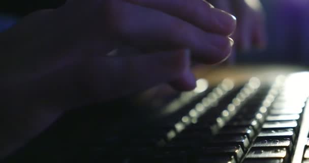 Typing on keyboard at night. Dark background lighting. Close-up — Stock Video