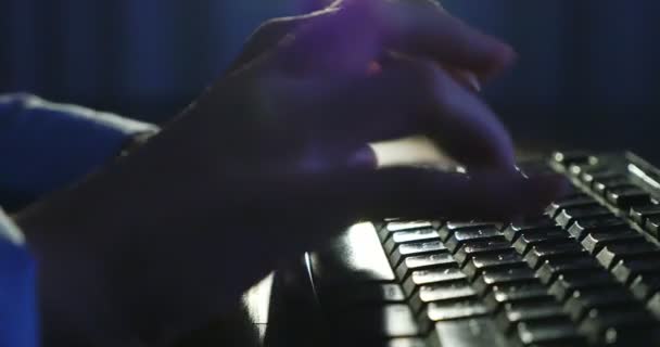 Typing on keyboard at night. Dark background lighting. Close-up — Stock Video