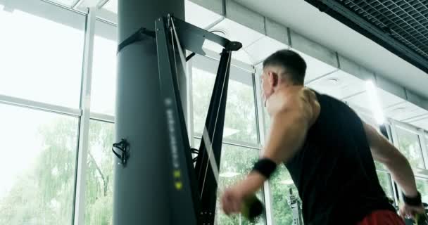 Strong Muscular male working on skis simulator. Cross Fitness Training in the gym — Stock Video