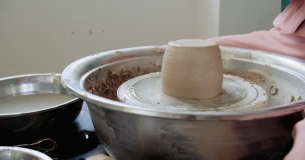 Žena hrnčíř sedí a dělá šálek na hrnčířském kole. Žena vyrábějící keramické předměty. Pottery working, handmade and creative skills — Stock video