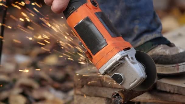 Il lavoratore taglia la struttura metallica con una rettificatrice . — Video Stock