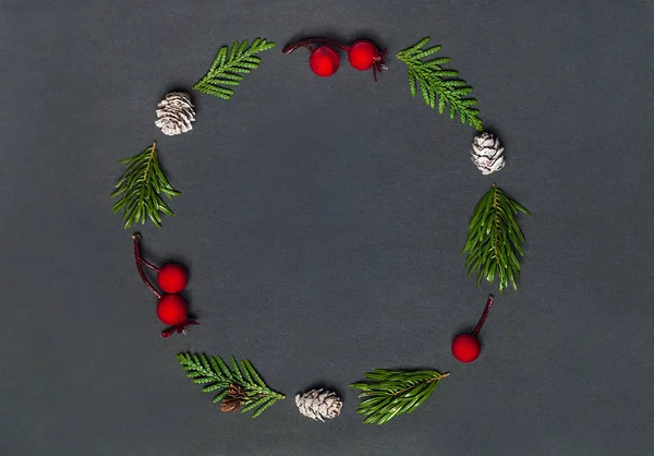 Christmas elegant wreath on black background, top view