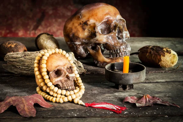 Eski ahşap zemin üzerinde kafatası tespih.