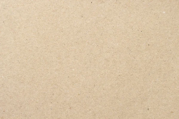 Cardboard, beige paper texture cardboard background close-up, surface with small inclusions of cellulose — Stock Photo, Image