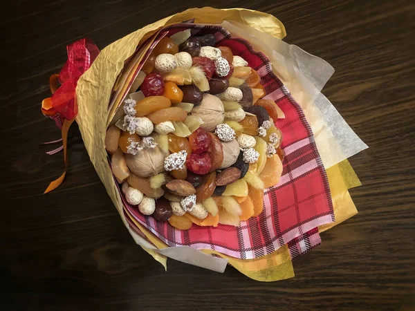Delicious and healthy bouquet, composition of dried fruits and nuts, excellent gift for all occasions, concept of healthy lifestyle