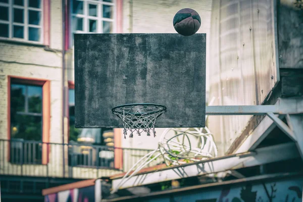 Street basketball game. Basketball shield, ball flies to the basket. Accurate throw in basketball ring. Concept of sport, hit accuracy, active lifestyle