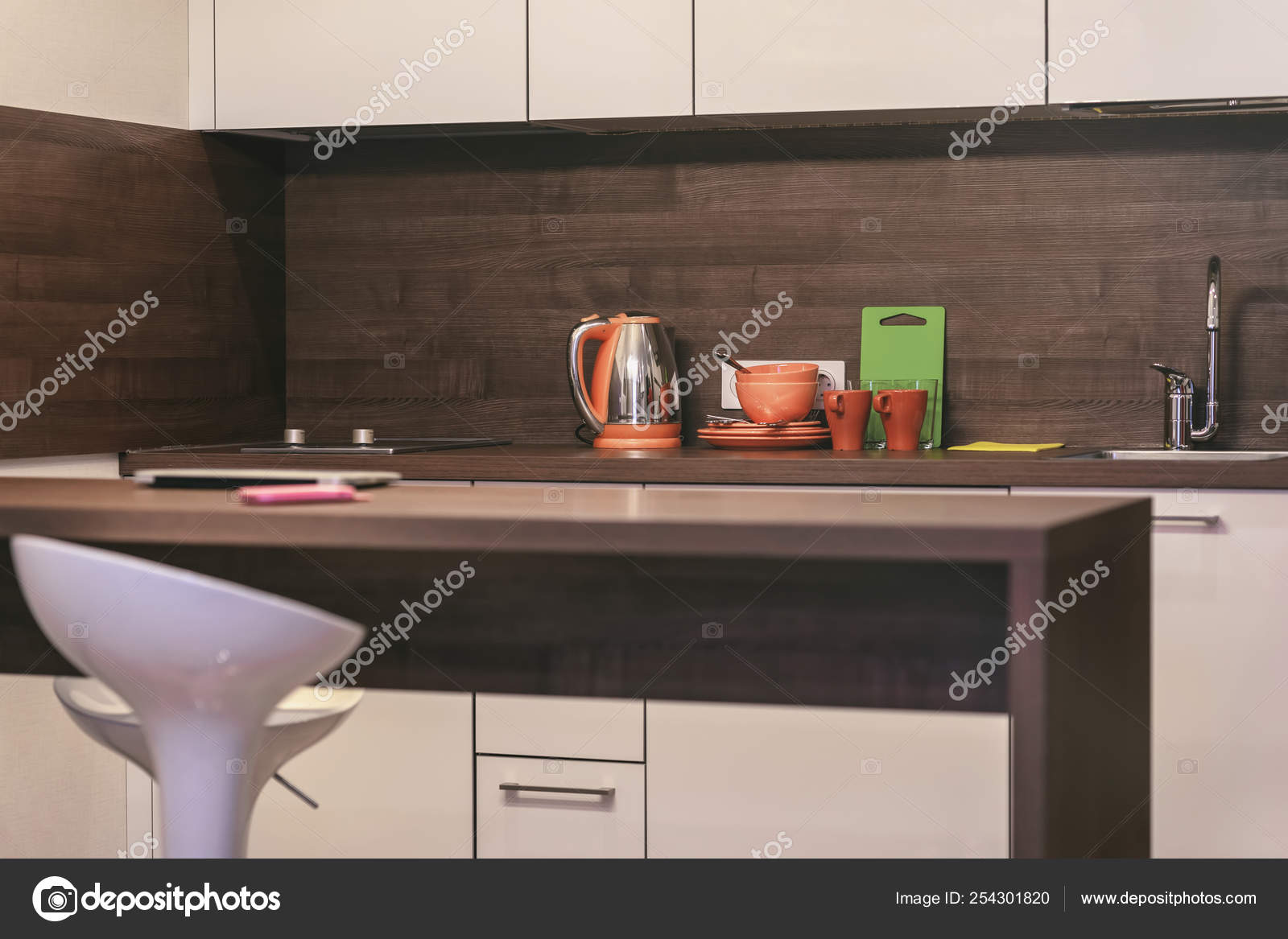Modern Kitchen With Countertops Table And Bar Stool Dishes