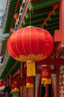 Geleneksel bir evin ön cephesinde kırmızı fenerli yuvarlak Çin feneri.