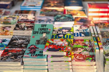 BURGAS, BULGARIA - AUGUST 01, 2025: Colorful stacks of manga books on table, Japanese comic covers. Concept of manga culture, Japanese comics books, youth entertainment, hobby of readers, collectors