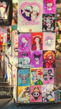 BURGAS, BULGARIA - AUGUST 01, 2025: Vertical colorful display of anime fan art posters, manga stickers with popular characters. Concept of anime fan art, manga design, otaku, kawaii culture