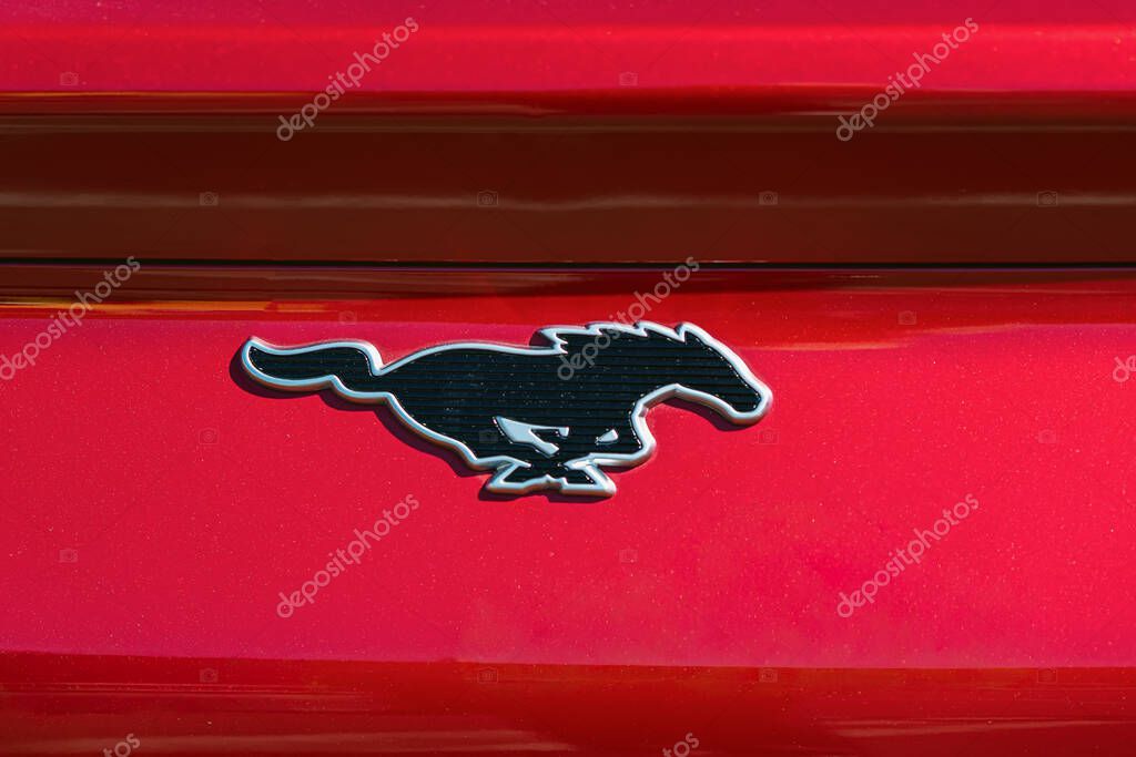 BURGAS, Bulgaria - September 20, 2025: Ford Mustang logo displayed on glossy red car surface, automotive branding and design elements. Concept of speed, automotive power, legendary car identity