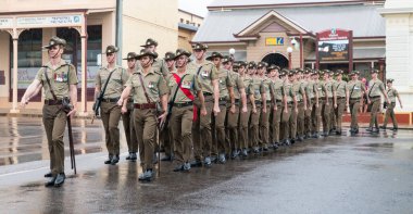 Charters Towers, Australia - April 25, 2019: Soldiers of the 1st Battalion, Royal Australian Regiment (1 RAR) marching in the rain on Anzac Day clipart