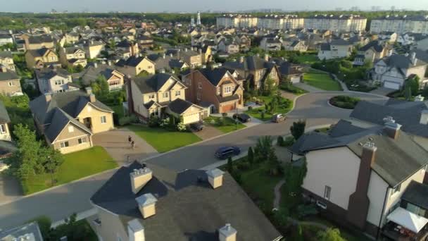 Happy children with bicycle in courtyard cottage home suburban village real estate comfortable villas club houses. Beautiful comfortable safe area infrastructure. Modern suburb landscape. Drone around — Stock Footage Happy Children Bicycle Courtyard Cottage Home Suburban Village Real Estate Royalty Free Stock Footage