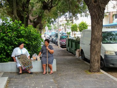 Rhodes, Rhodes island, Greece - October 8, 2014: On a city street. The measured, unhurried life of local residents clipart