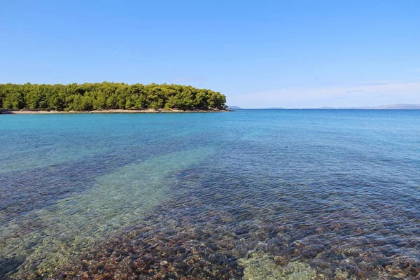 Hermoso paisaje de la costa del mar Adriático con agua azul transparente cerca de Supetar, Croacia. Destinos turísticos populares . — Foto de Stock