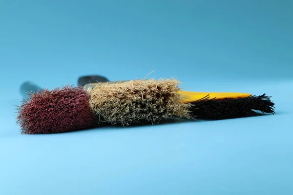 A some cosmetic brushes for beautify yourself in every morning. Blue background