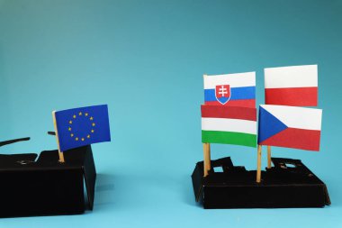 A one side Vysegrad four fighting for own interest and on the second side Europe union figting for nothing. Blue background clipart
