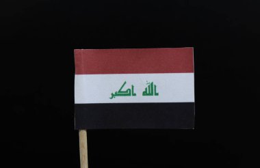 A unique flag of Iraq on toothpick on black background. A horizontal tricolour of red, white, and black, charged with the text  in green Kufic script, centered on the white stripe. clipart