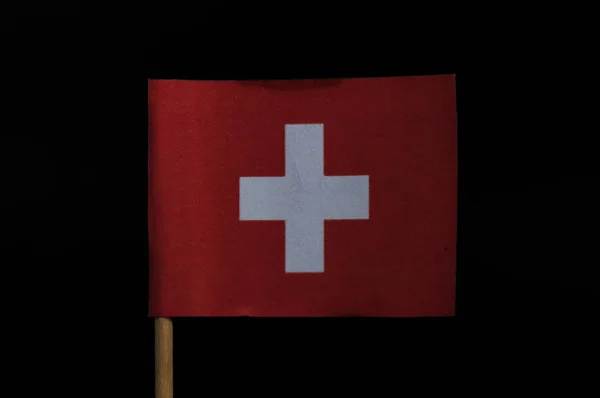 素晴らしいとオリジナル国旗スイス連邦共和国の黒い背景につまようじで 中心部に白い十字と赤の背景に正方形の旗 — ストック写真