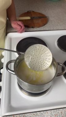 Stirring ghee on the stove with a metal spoon