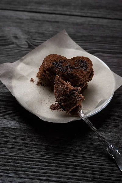 巧克力甜点以一种心的形式躺在木质的背景上 — 图库照片