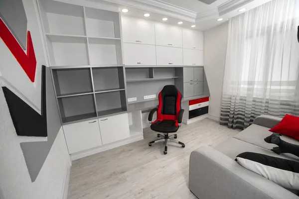 Red and black armchair in the office with white furniture