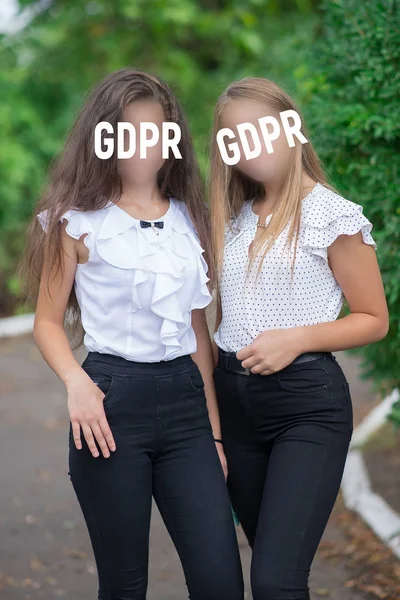 GDPR - girls hide faces with the inscription General rules for data protection. Cyber Security and Privacy