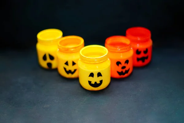 decorated halloween jars with cute grimaces, funny monsters happy halloween