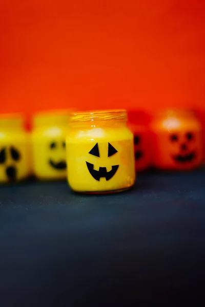 decorated halloween jars with cute grimaces, funny monsters happy halloween