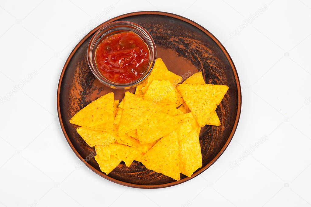 Mexican food concept. Yellow corn totopos chips with sauce. Top view.