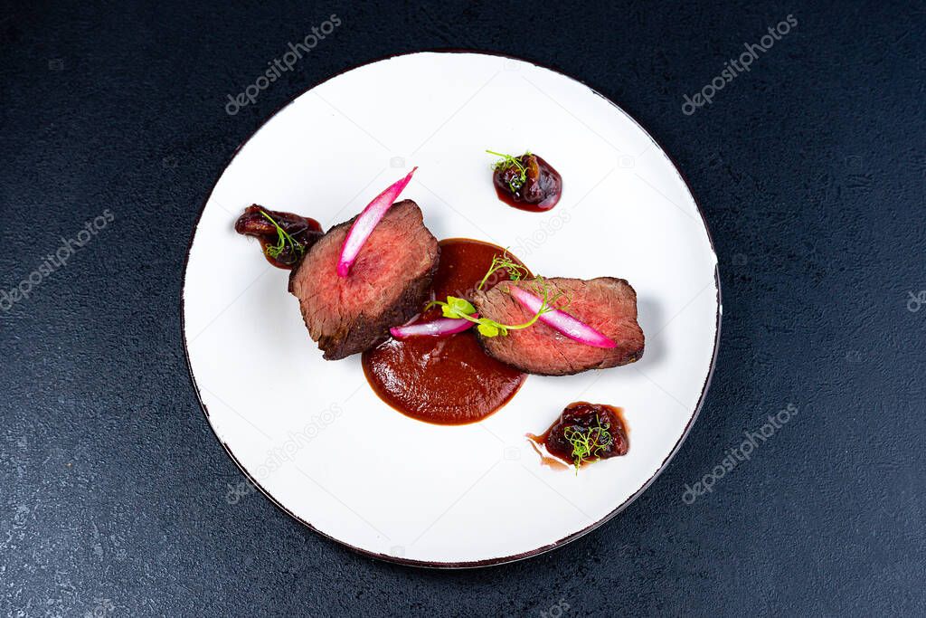 Medium Rare Filet mignon steak on white plate , selected focus top view
