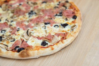 Pizza lezzetli klasik tarzı ahşap masa arka plan üzerinde. Taze gıda çeşitli, closeup üst görünüm promosyon fotoğraf. İtalyan geleneksel kültür