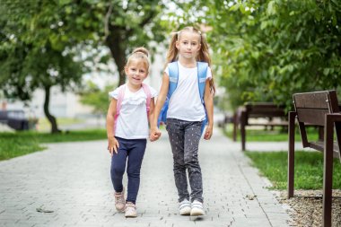 İki kız kardeş okula gidiyorum. Okul, eğitim, eğitim, dostluk, çocukluk kavramı