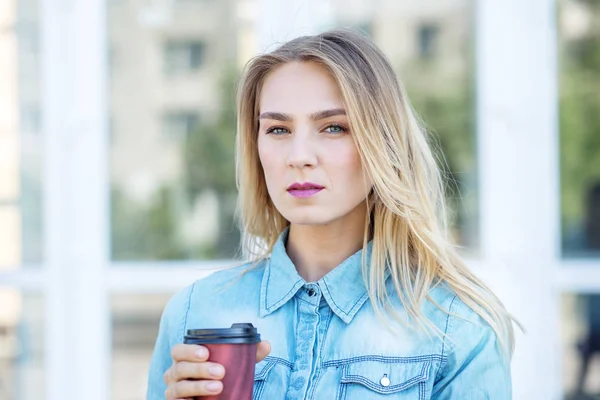 Young serious woman with coffee. Concept of life style, urban, youth