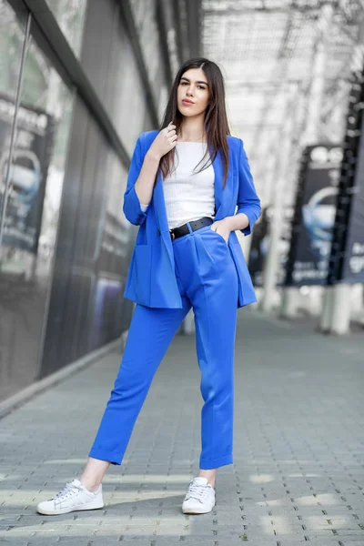 stock image Beautiful brunette model posing in blue clothes. The concept of 