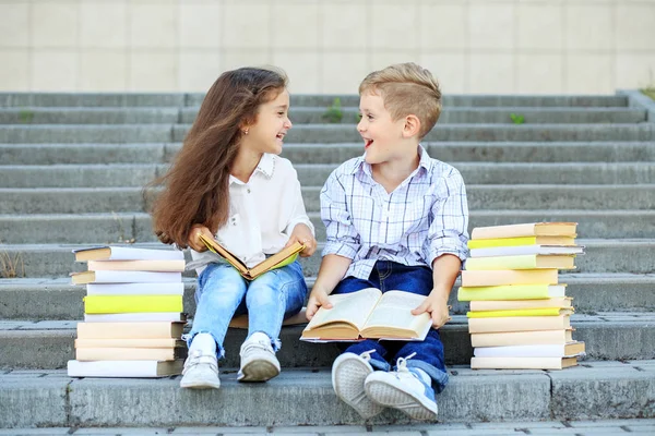 Два студента читают книги и общаются. Концепция вернулась в школу, образование, чтение, дружбу и семью — стоковое фото
