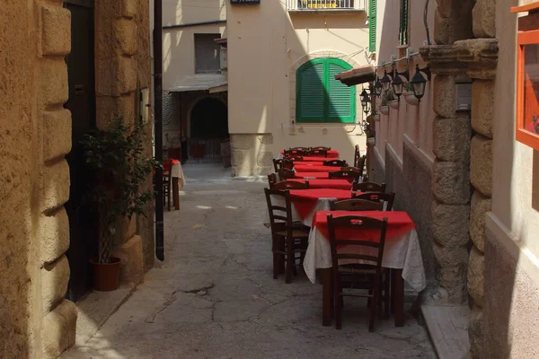 traditional restaurant exterior with tables and chairs on the street