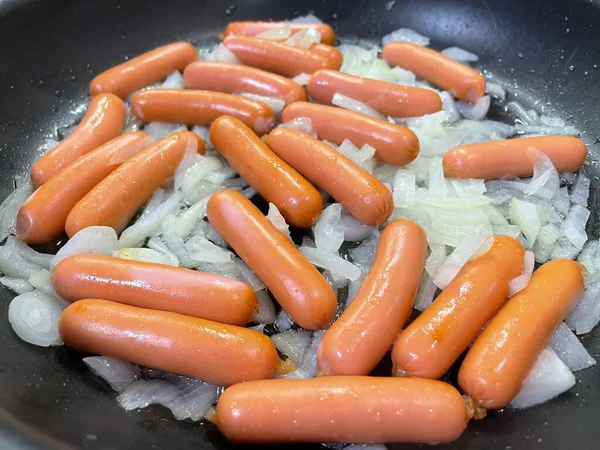 Tavada taze çiğ sosis.