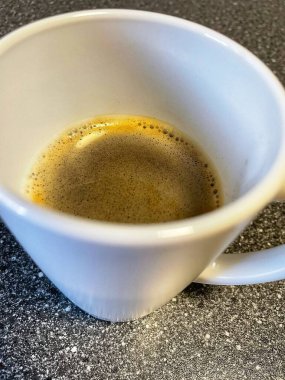 Tahta bir masada, fincanda kahve.