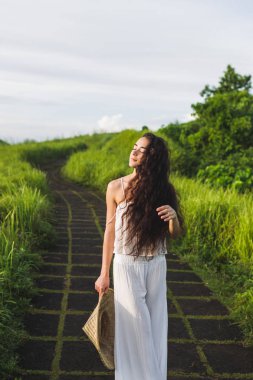 Campuhan Ridge sanatçılar, Ubud, Bali yolda yürürken beyaz elbiseli Genç kadın portresi.