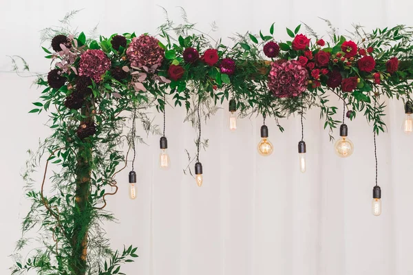 婚礼招待会装饰用电爱迪生电灯泡和新鲜的红色花 质朴样式 — 图库照片