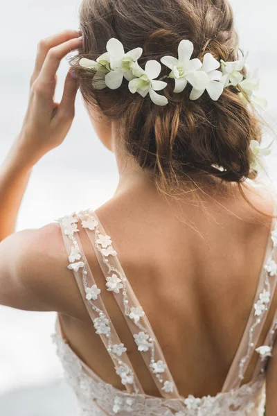 rear view of bride hairstyle with wreath of orchids