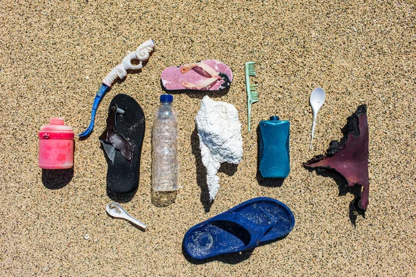 Various types of plastic waste collected on the beach on sand ba