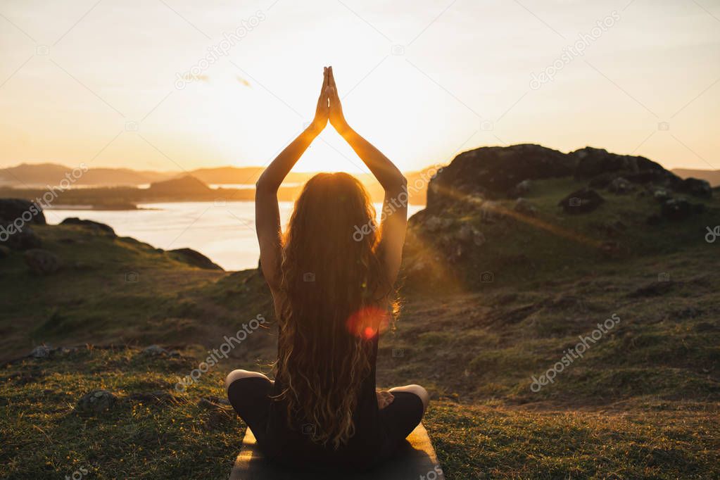 Young woman practicing yoga outdoors.  Spiritual harmony, intros