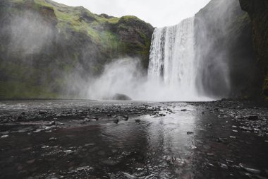 Skogafoss Iceland famous waterfall. Powerful stream, dramatic vi clipart