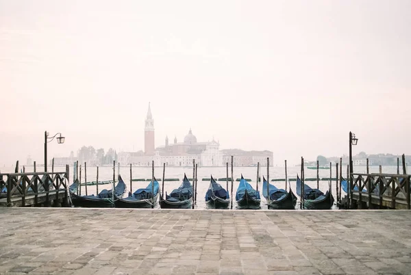 View of Venice lagoon with gondolas and San Giorgio Maggiore on