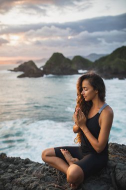 Genç kadın dua ve beautifu ile gün batımında yalnız meditasyon