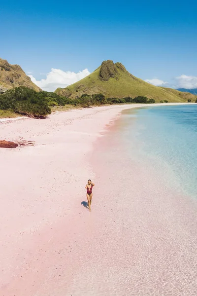 Woman walking and enjoying empty paradise tropical beach. Nobody