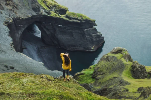 Жінка дивиться на скандинавський пейзаж з відсутністю піщаного вулканічного пляжу , — стокове фото